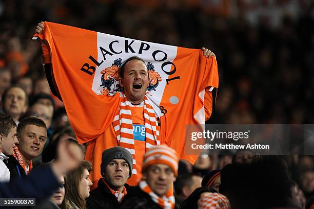 Fan of Blackpool holds up his flag after his team went 2-0 ahead against Tottenham Hotspur