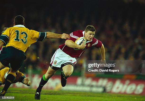 Brian O'Driscoll of the British Lions takes the ball past Daniel Herbert of Australia during the British and Irish Lions tour match between Australia...