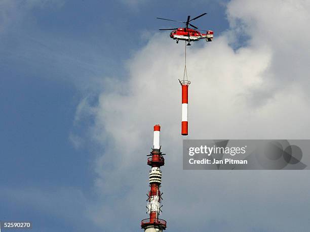 New antenna is lifted into place by a helicopter on the Olympic Tower Munich on April 5, 2005 in Munich, Germany. The new antenna is needed for the...