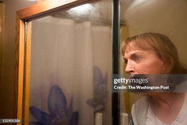 Kendall Balentine cleans the mirror of her bathroom at her home outside Deadwood in the Black Hills of western South Dakota on Saturday, April 16,...