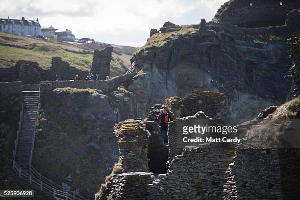 People visit the ruins of Tintagel Castle in Tintagel on April 28, 2016 in Cornwall, England. The English Heritage managed site and the nearby town...
