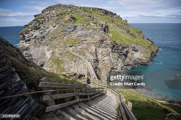 People visit the ruins of Tintagel Castle in Tintagel on April 28, 2016 in Cornwall, England. The English Heritage managed site and the nearby town...