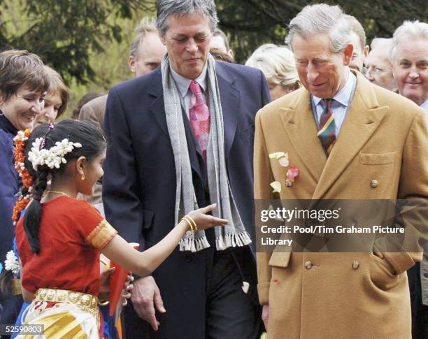 Prince Charles has flower petals thrown in front of him as he arrives for the consecration of the Stupa Buddhist Religious Monument at Harewood House...