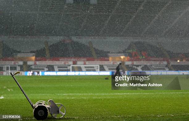 Groundstaff at The Liberty Stadium home of Swansea City prepare the pitch in the snow before the Capital One - Semi Final Second Leg - Swansea City v...