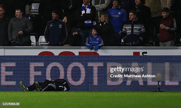 The ball boy kicked by Eden Hazard of Chelsea lies injured on the side of the pitch