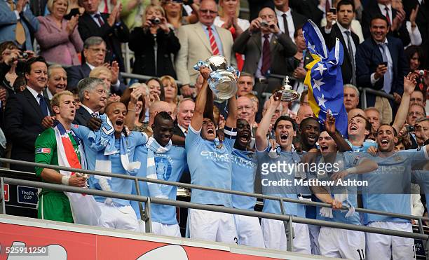Carlos Tevez of Manchester City lifts the FA Cup Trophy - Joe Hart, Prime Minister David Cameron