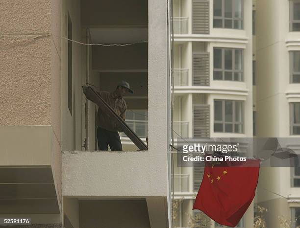 Worker works at a building under construction on April 5, 2005 in Shanghai, China. The China Banking Regulatory Commission is carrying out...