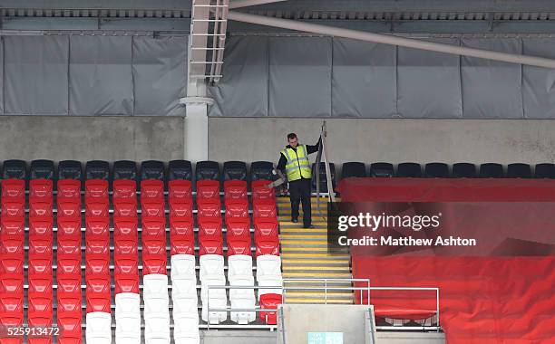 Steward removes storm damage to the Ninian Stand at The Cardiff City Stadium home of Cardiff City Football Clubs ground