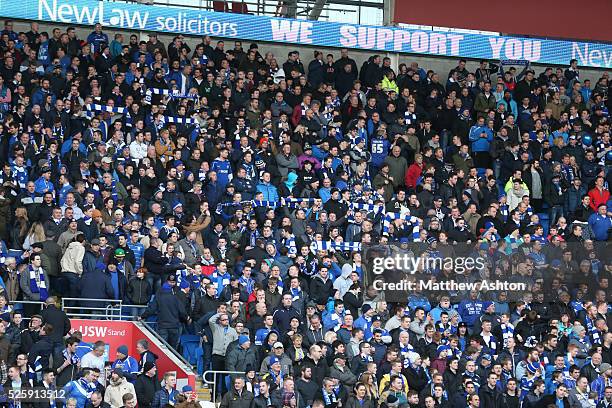 Blue and white scarfs being held by the fans of Cardiff City. Cardiff City have returned to their traditional all blue kit for their home kit. The...