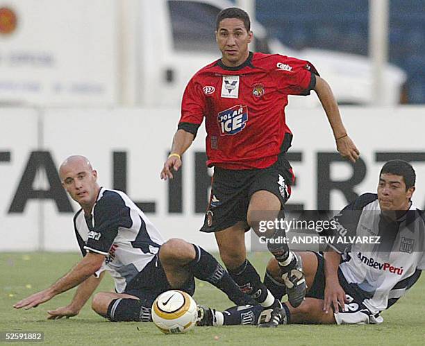 El delantero del Caracas Rafael Castellin disputa el balon con Pedro Aparicio e Ivan Furios del Alianza Lima el 05 de abril de 2005 en Caracas...