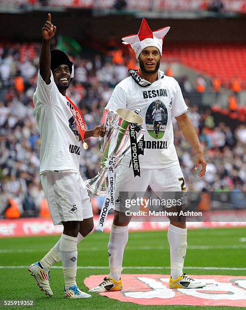 Nathan Dyer and Ashley Williams of Swansea City celebrate with the nPower Football League Championship trophy and promotion to the Premier League...