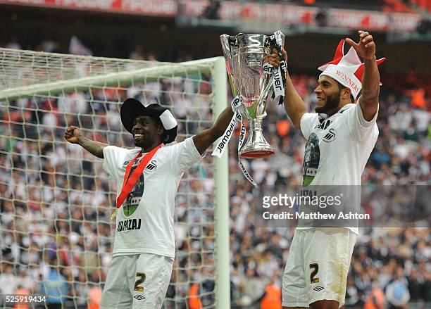 Nathan Dyer and Ashley Williams of Swansea City celebrate with the nPower Football League Championship trophy and promotion to the Premier League