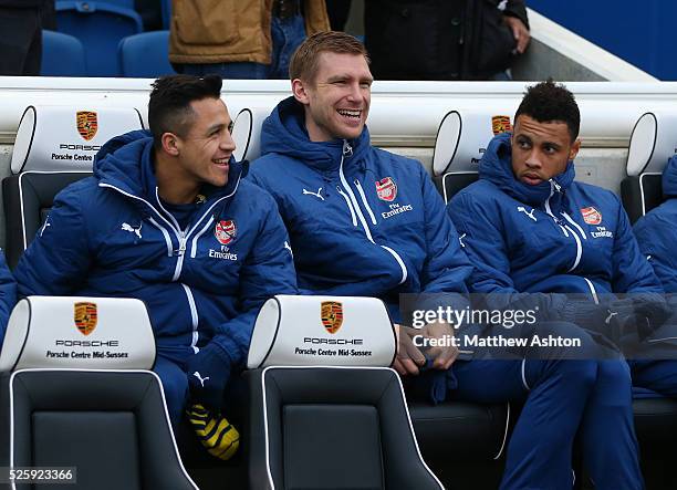 Alexis Sanchez, Per Mertesacker and Francis Coquelin of Arsenal on the bench