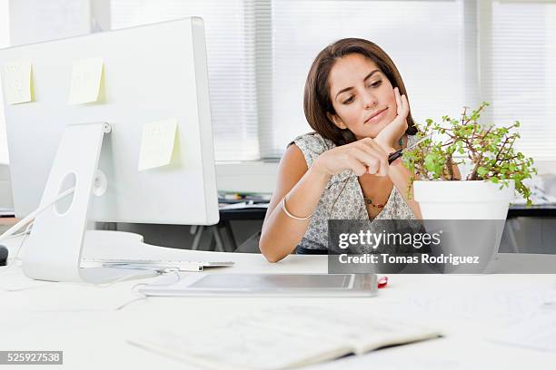 young businesswoman daydreaming in office - sticky-notes-covering-computer-monitor stock pictures, royalty-free photos & images