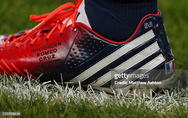 David Beckham of Paris Saint-Germain warms up before the game wearing Adidas football boots with a French flag and the names of his four children,...