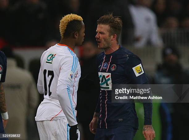 David Beckham of Paris Saint-Germain squares up to Jordan Ayew of Olympique de Marseille after a bad tackle