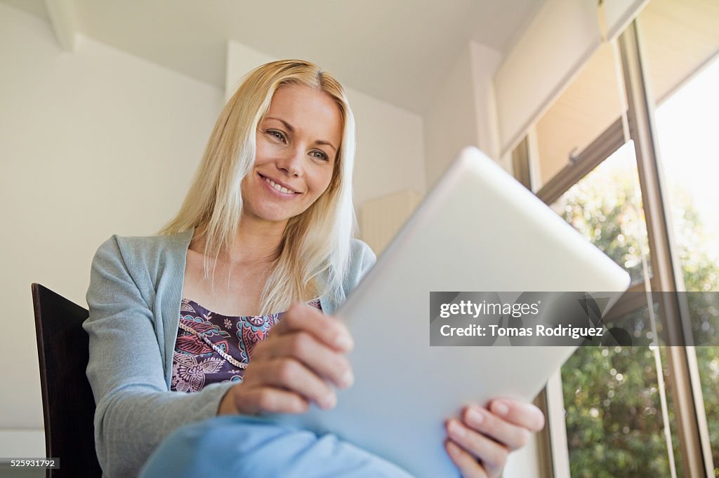 Woman using tablet pc at home