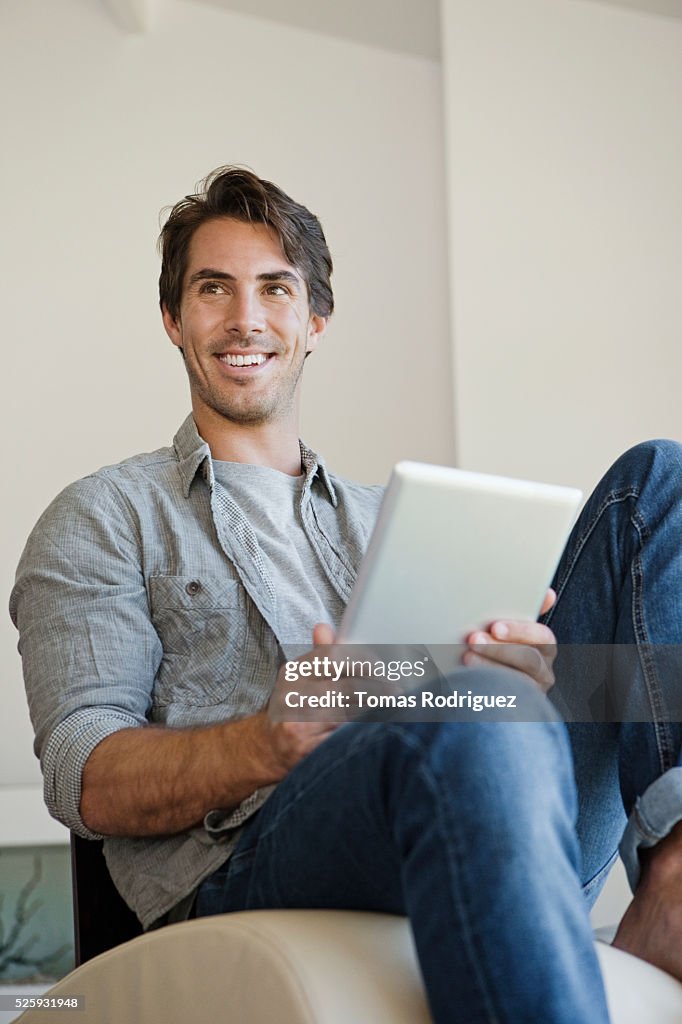 Man using tablet pc at home