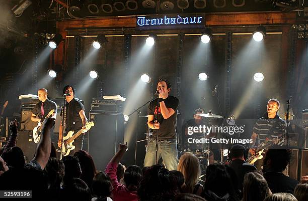 Musicians Jeff Stinco, David Desrosiers, Pierre Bouvier, Chuck Comeau and Sebastien Lefebvre of the band Simple Plan perform onstage during the AOL...