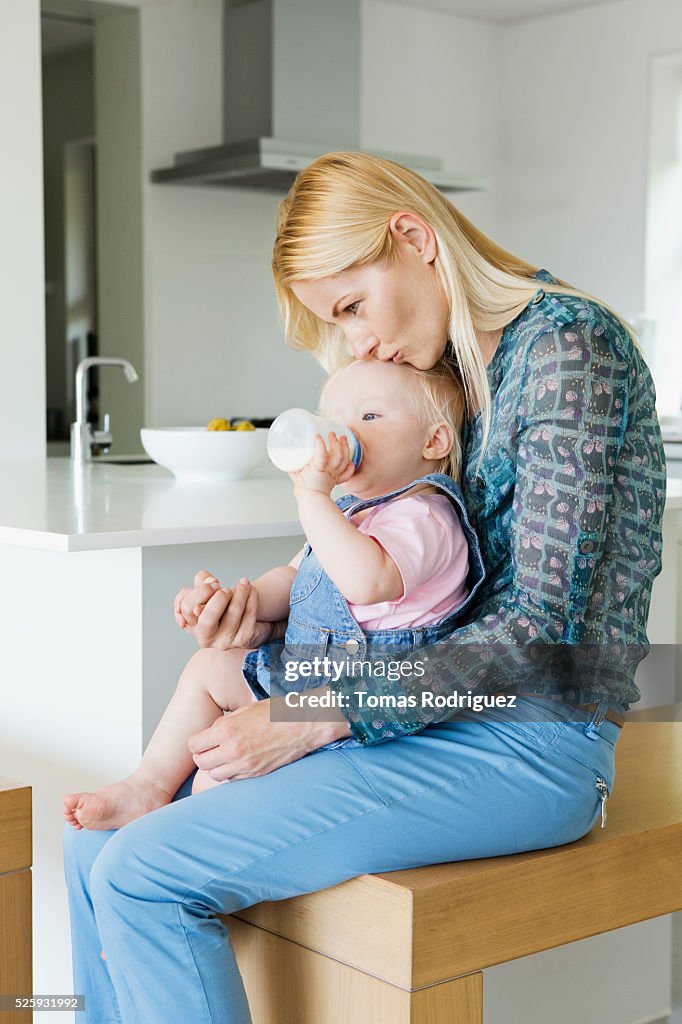 Mother and daughter (12-23 months) at home