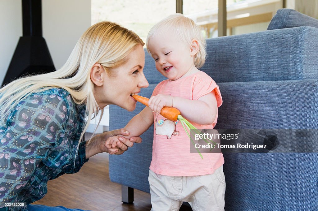 Mother and daughter (12-23 months) at home