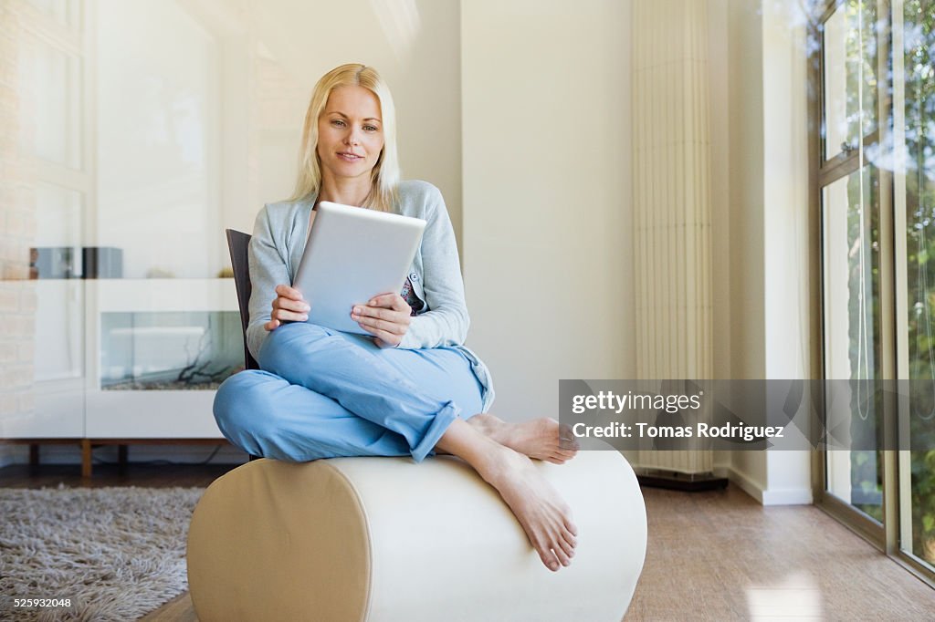 Woman using tablet pc at home