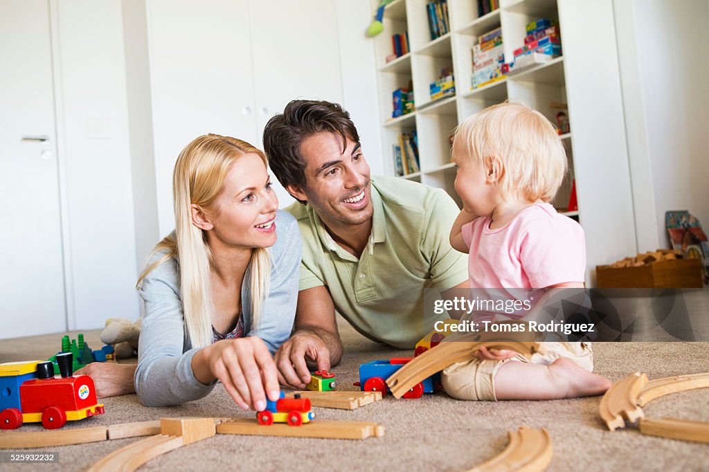 Parents playing with daughter (12-23 months) at home