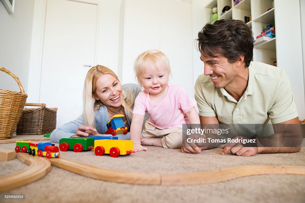 Parents playing with daughter (12-23 months) at home