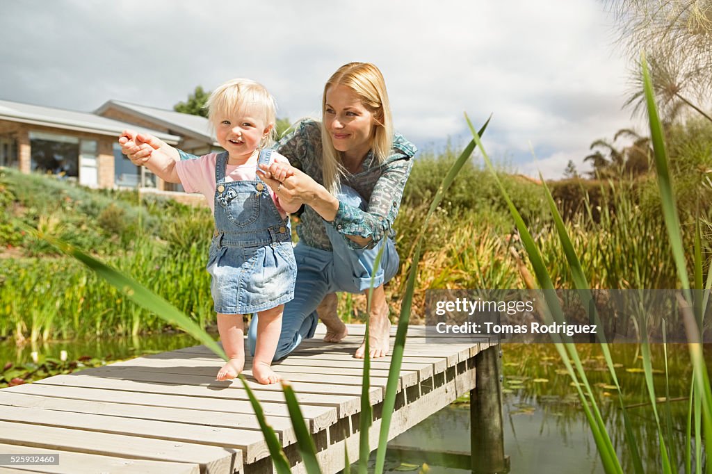 Mother and daughter (12-23 months) on jetty