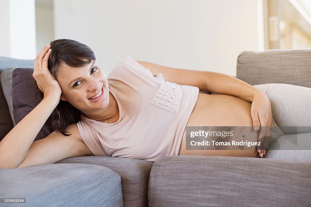 Pregnant woman lying on sofa