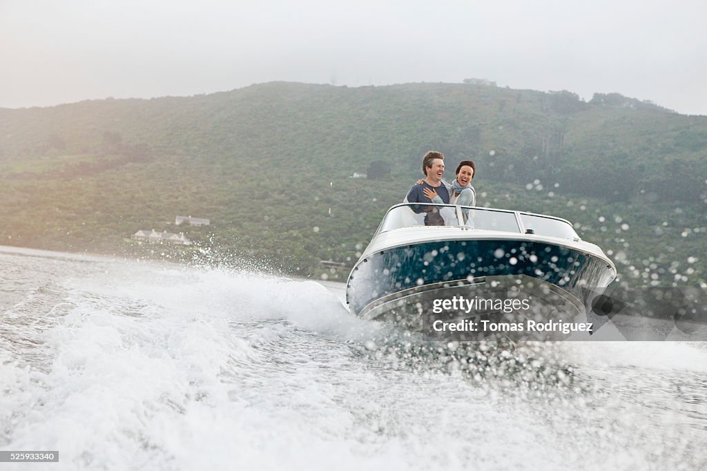 Couple speeding on motorboat