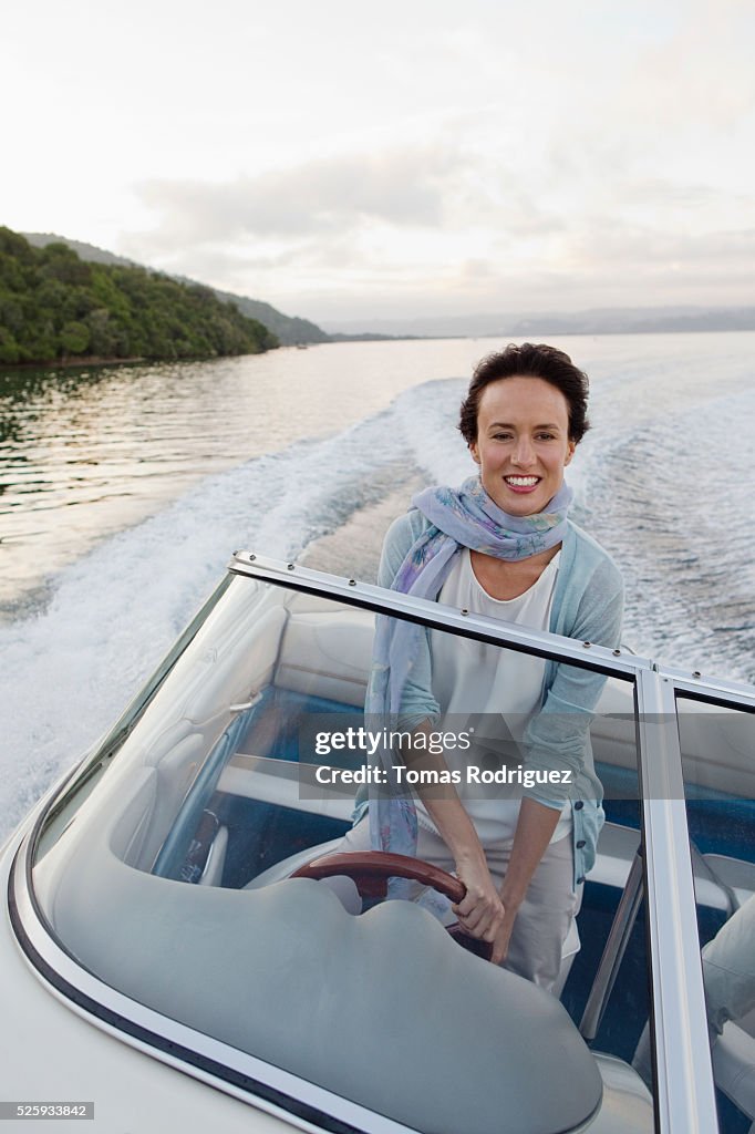 Woman steering motorboat