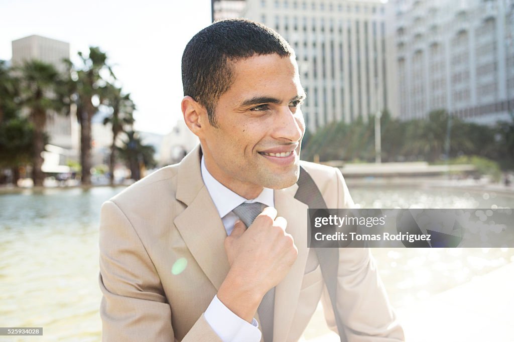 Portrait of mid adult man resting by fountain