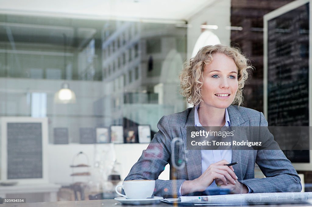 Portrait of mid adult woman relaxing in coffee shop