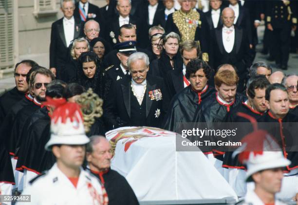 Prince Rainier of Monaco, accompanied by his daughter Princess Caroline and his son Prince Albert walk behind the coffin of his wife, Princess Grace...