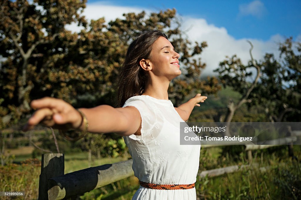 Young woman with eyes closed in sunlight