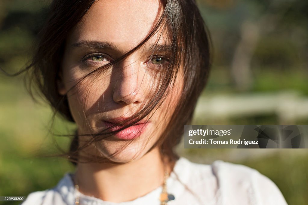 Portrait of young woman with hair on face