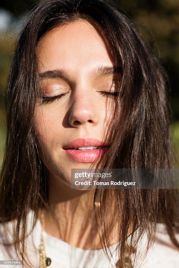 Portrait of young woman with eyes closed