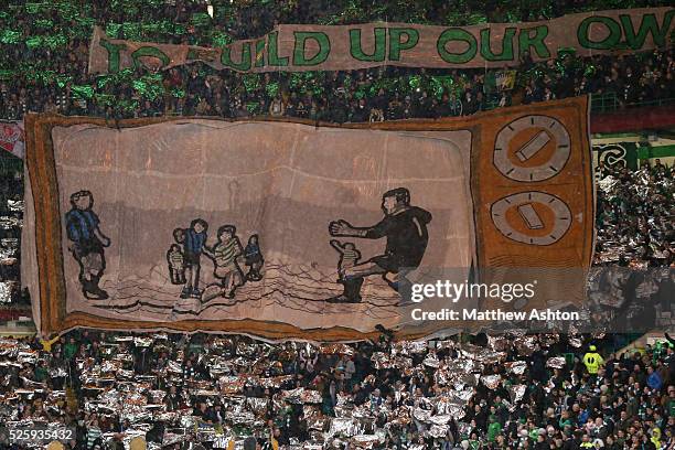 The Celtic Ultras show a banner saying IT IS UP TO US TO EVERYONE AT CELTIC PARK TO BUILD UP OUR OWN LEGENDS with an image of a TV showing Celtic...