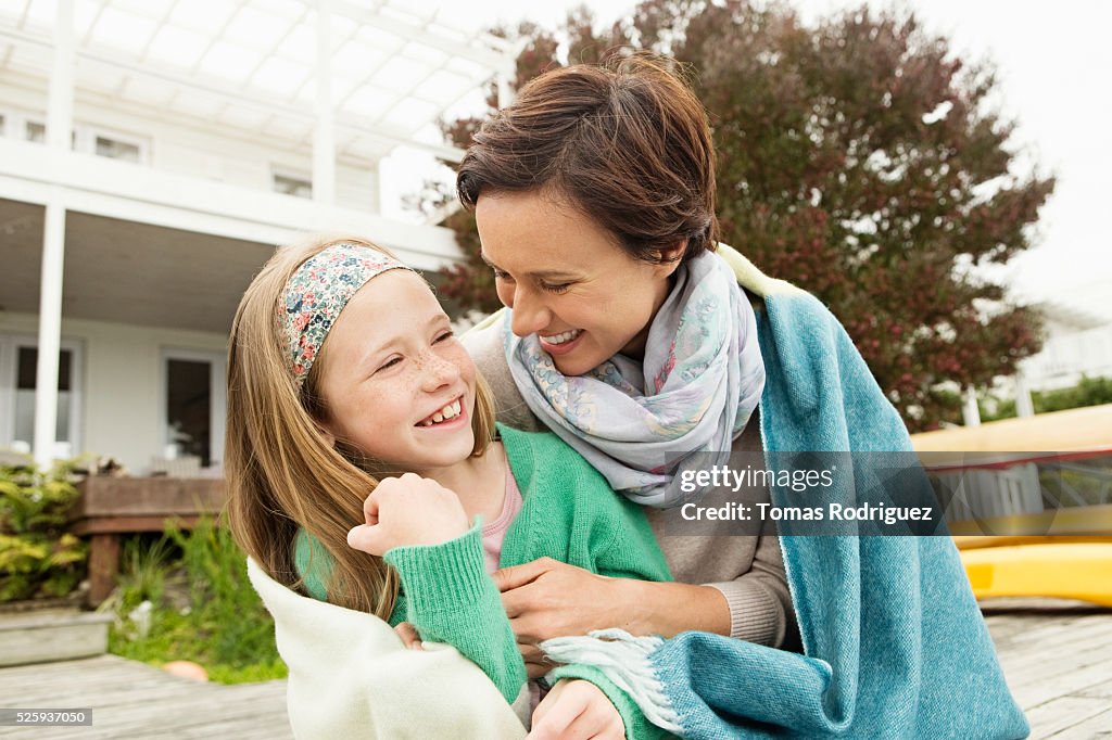 Portrait of woman and girl (8-9) relaxing