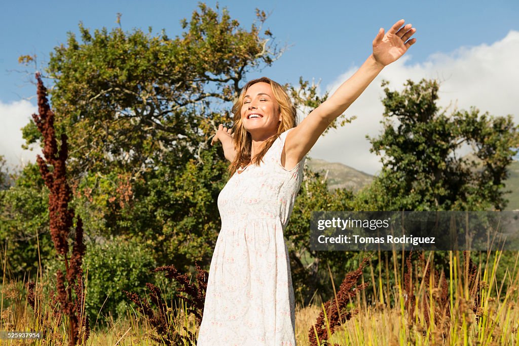 Yyoung woman among field at sunny day