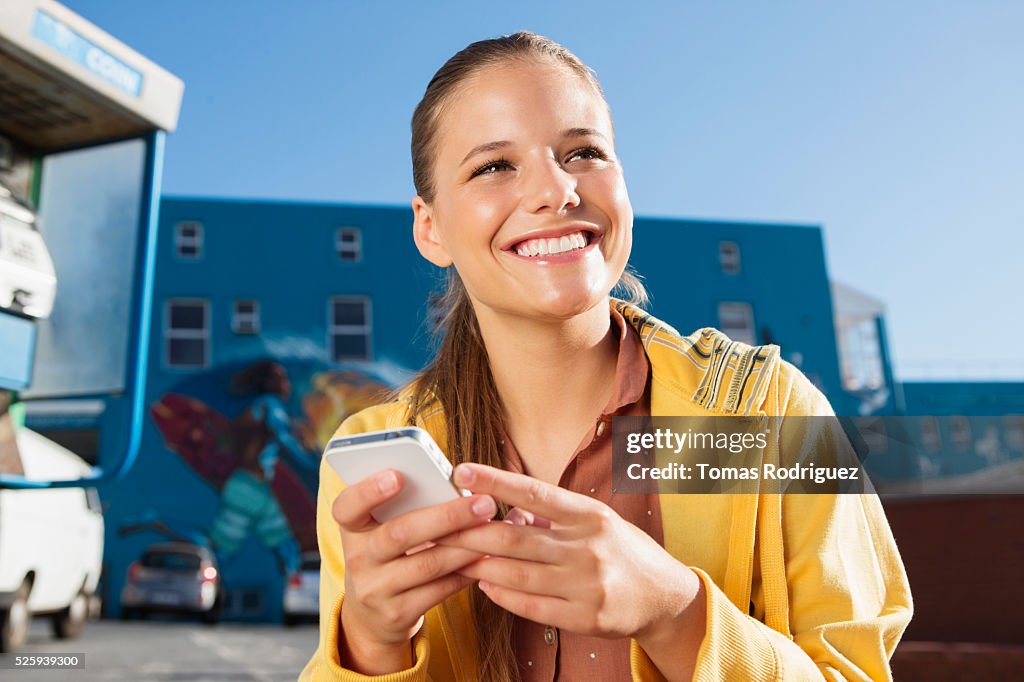 Young woman texting on smartphone