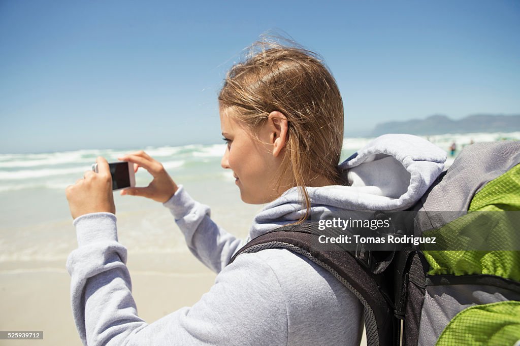 Woman photographing sea