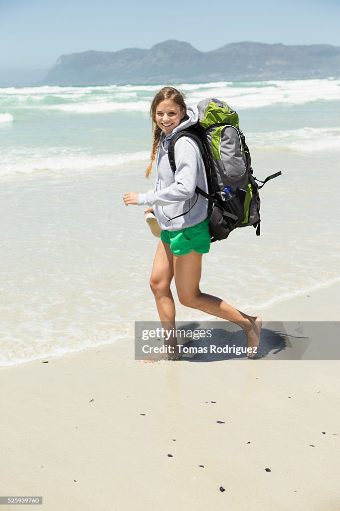 Backpacker walking on beach