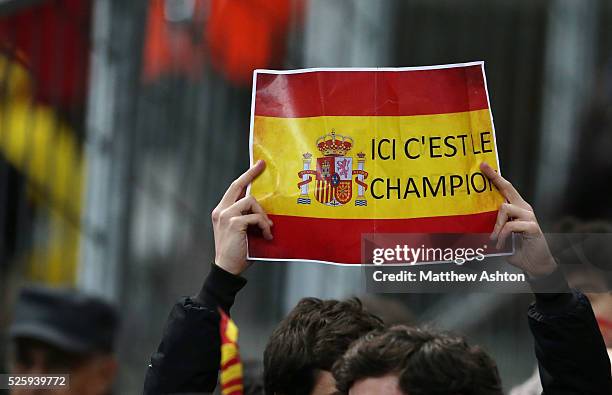 Spain fan holds up a sign saying We are the Champions