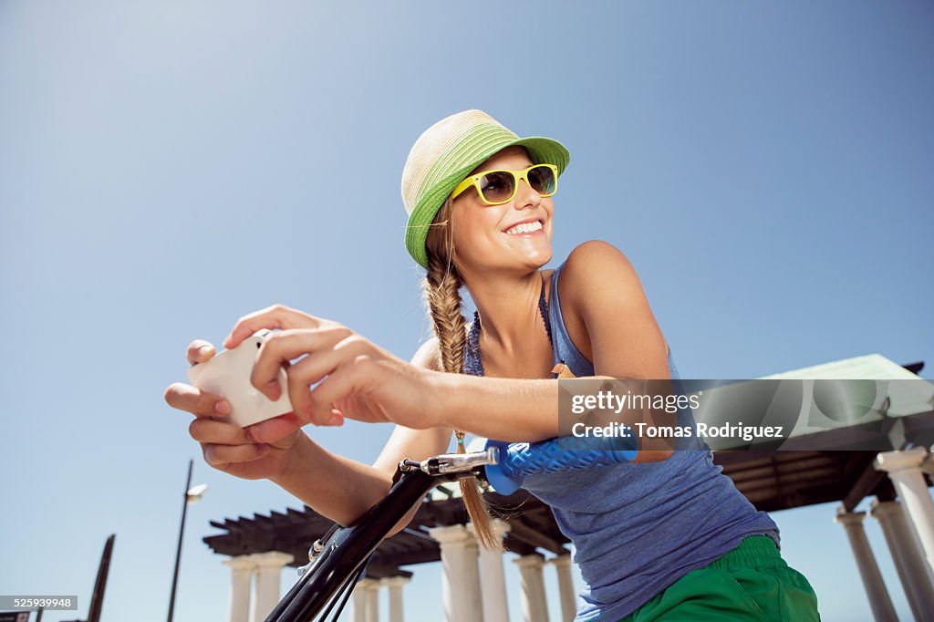 Woman riding bicycle and text messaging