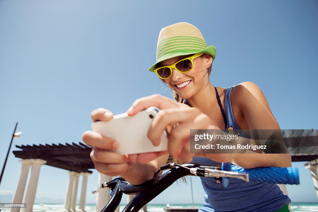 Woman riding bicycle and text messaging