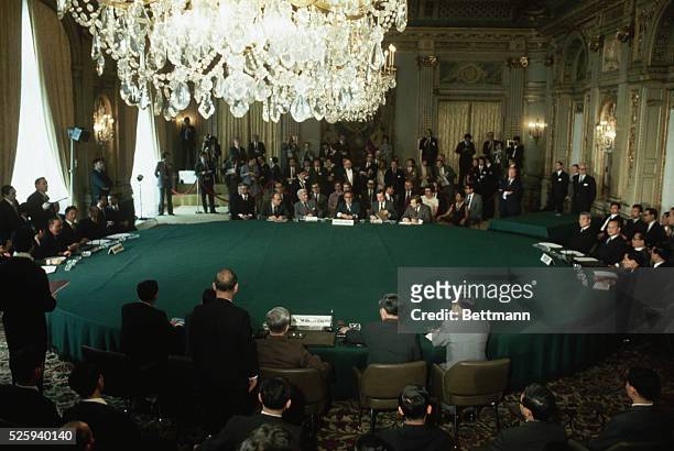 Representatives from the four factions of the Vietnam War meet in Paris to sign a peace agreement. On the left are representatives from South Vietnam...