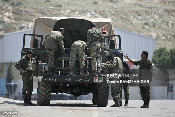 Syrian soldiers fix their military truck before leaving Lebanon near the al-Masnaa border point in the Bekaa valley, 06 April 2005. Syria is expected...