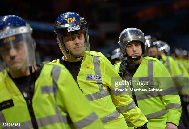 Police draw batons and form a line to stop Aston Villa fans as they try to get to the West Bromwich Albion Fans in the final few minutes of the match...